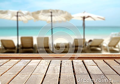 Wood table top on blurred blue sea and white sand beach background. Stock Photo