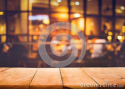 Wood table top on blurred of cafe restaurant with light gold Stock Photo