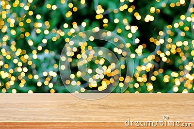 Wood table top with bokeh background from decorative light on christmas tree Stock Photo