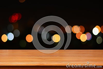 Wood table top on colorful bokeh background at night Stock Photo