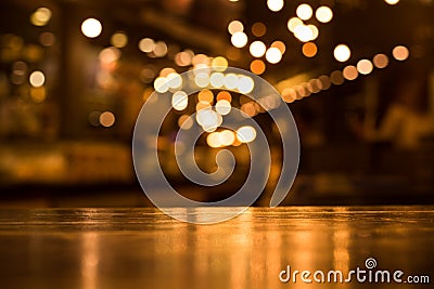 Wood table top with reflect on blur of lighting in cafe,restaurant Stock Photo