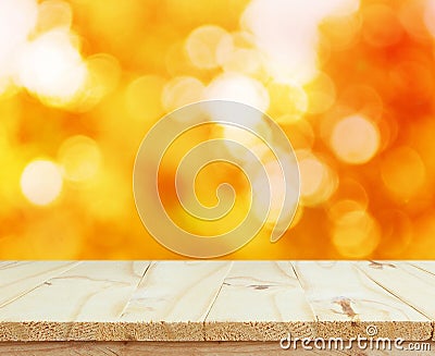 Wood table top on shiny bokeh gold background Stock Photo