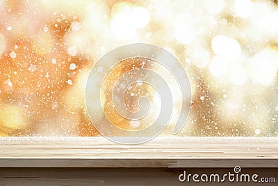 Wood table top on shiny gold bokeh abstract background with snow Stock Photo