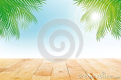 Wood table top on summer tropical sky background with green coconut leaves Stock Photo
