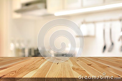 Wood table top (as kitchen island) on blur kitchen interior back Stock Photo