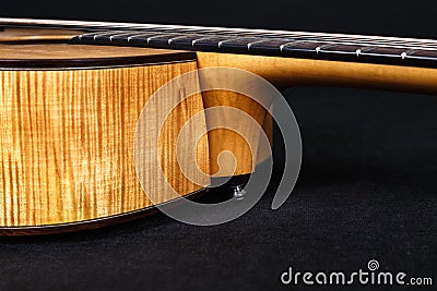 Wood texture of lower deck of six strings acoustic guitar on black background. guitar shape Stock Photo