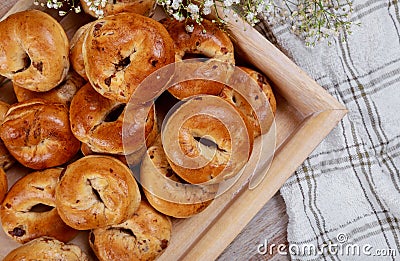 A tray of homemade traditional buns, the yellow buns have raisins and cinnamon Stock Photo