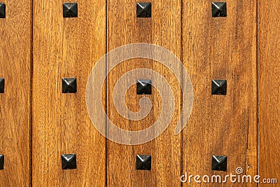 Wood wall texture. Abstract background of wooden door surface with black iron rivets, nails Stock Photo