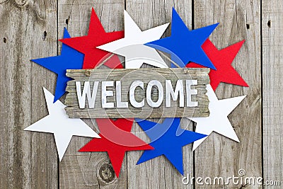 Wood welcome sign surrounded by red, white and blue stars Stock Photo