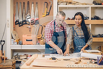 wood workshop worker working together home renovate plan project discussion Stock Photo