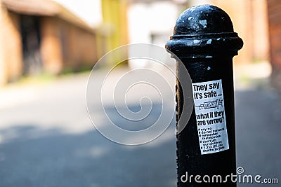 Woodbridge Suffolk UK July 21 2021: An anti vaccination sticker that has been stuck and littered around a town centre spreading Editorial Stock Photo
