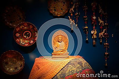 Woodcarving buddha on table in display window Editorial Stock Photo