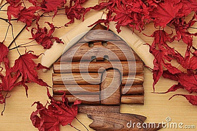 Woodcraft cabin house and dry maple leaves Stock Photo