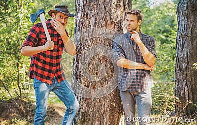 Woodcutters lumberjacks. Hipsters men on serious face with axe. Lumberjack brutal and bearded holds axe. Two lumberjacks Stock Photo