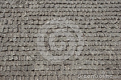 Wooden aged tile on the roof of the house, natural surface texture background Stock Photo