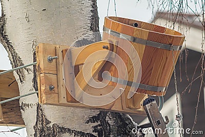 Wooden antique bucket for watering, pouring cold water Stock Photo