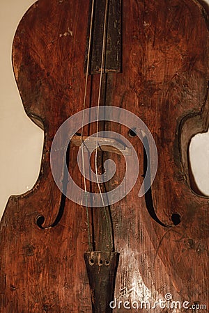 Wooden antique musical instrument. A wooden musical instrument is brown. Stock Photo