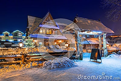 Wooden architecture of Zakopane at snowy night, Poland Editorial Stock Photo