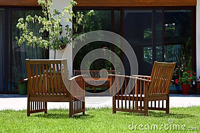 Wooden armchairs in beautiful garden Stock Photo