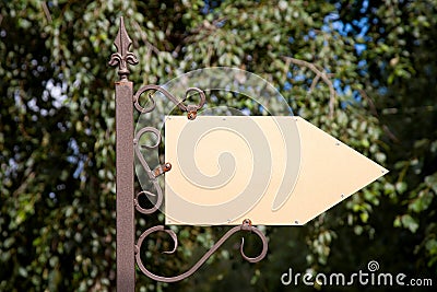 Wooden arrow cursor on a metal pole Stock Photo