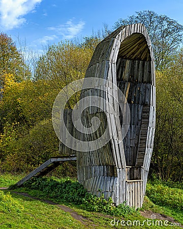 Wooden art object Nicolin Ear - a wide ear-shaped bell, located at the edge of the hill. Kaluga region, Russia Editorial Stock Photo