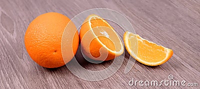 On a wooden background orange, half an orange and a slice Stock Photo