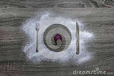 Wooden background powder powdered snow embroidered silhouette plate fork knife appliances Christmas tree ball sparkles pink Stock Photo