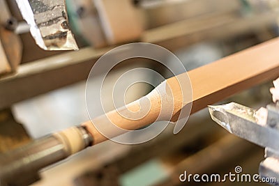 Wooden baluster lathe, unfocused background, shaped. Carpentry Stock Photo