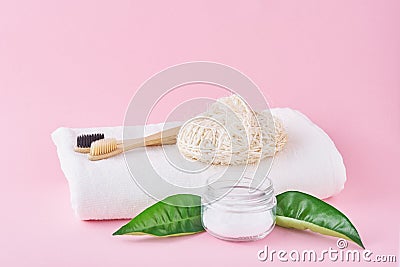 Wooden bamboo toothbrushes and baking soda on a pink background. Dental care and hygiene concept Stock Photo