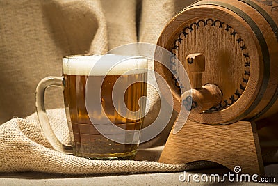 Wooden barrel with beer mug on canvas background Stock Photo