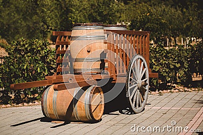 Wooden barrel with red and wihte wine for tasting in cart on the vineyard. Textured object Stock Photo