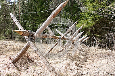 Wooden barricade with a barbed wire Stock Photo