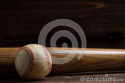 A wooden baseball bat and ball on a wooden background Stock Photo