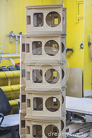 Wooden bases Audio Speakers stacked like a tower at the factory Stock Photo