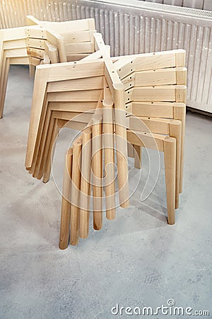 Wooden bases with legs for chairs assembling in paint booth Stock Photo