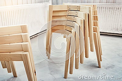 Wooden bases with legs for chairs assembling in paint booth Stock Photo