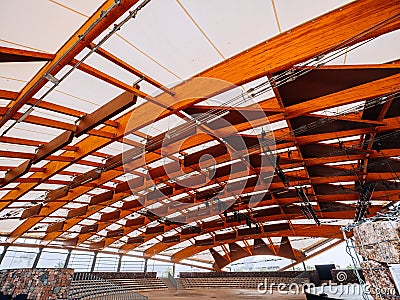 Wooden beams of a city concert hall also part of design. Modern technology using old materials Stock Photo