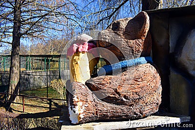 Wooden bear doll eating icecream in the park Stock Photo