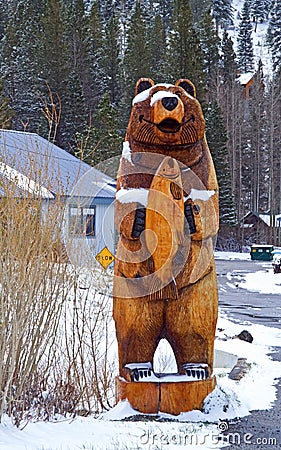 Wooden bear in snow Stock Photo