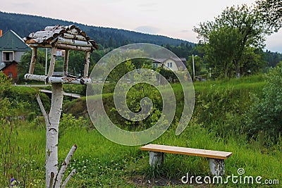 Wooden bench and birdhouse in Carpathians, Stock Photo