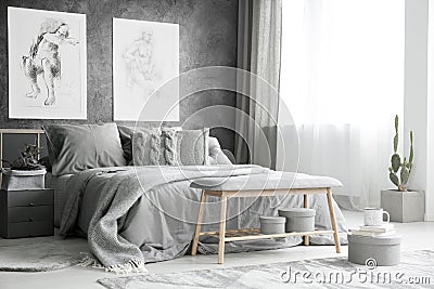 Drawings in bright grey bedroom Stock Photo