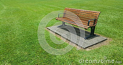 Wooden bench in a manicured lawn in Cairns Stock Photo