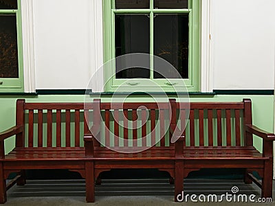 Wooden bench and sash window. A nostalgic image of a waiting room. Stock Photo
