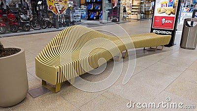 Wooden bench and trash can in the shopping mall. Recreation area in the shopping center with wooden benches and Editorial Stock Photo