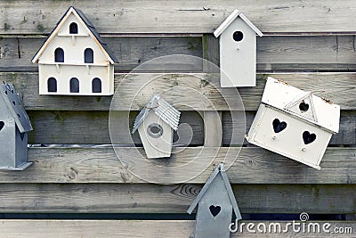 Wooden bird houses with heart shaped holes Stock Photo