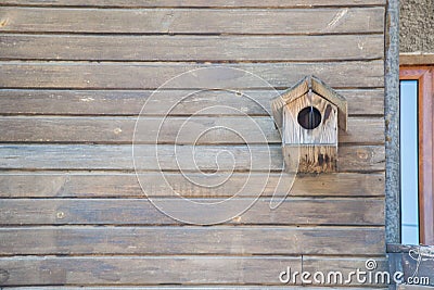 Wooden birdhouse on a wooden wall made from planks, background, copy space Stock Photo