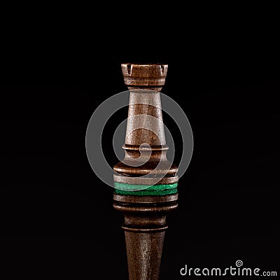 Wooden black chess rook isolated at dark background Stock Photo