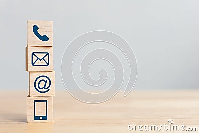 Wooden block cube symbol telephone, email, address and mobile phone. Website page contact us or e-mail marketing concept Stock Photo