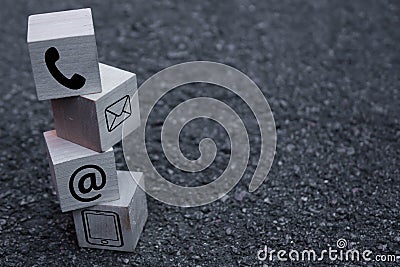 Wooden block cube symbol telephone, email, address. Website page contact us or e-mail marketing concept Stock Photo