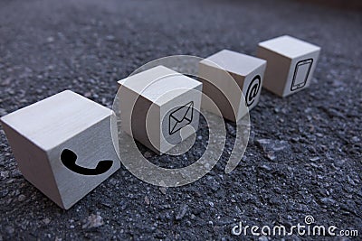 Wooden block cube symbol telephone, email, address. Website page contact us or e-mail marketing concept Stock Photo